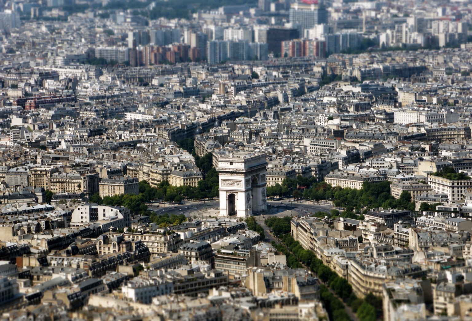 Aerial view across Paris with the Arc de Triomphe at the centre